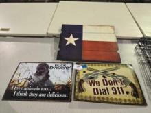 One Texas flag wall mount, and two tin signs.