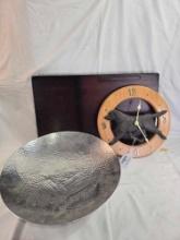Small wooden desk workstation, Aluminum fruit bowl, and a retriever wall clock.