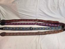 Four colorful cloth guitar straps.