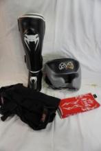Martial arts equipment. helmet, shin guard, wrist gloves, and leg weights.