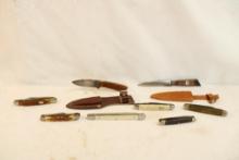 Six small folding pocket knives and 2 small fixed blade knives with leather sheaths