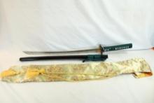 One single pin handle release short Samurai sword in silk bag.
