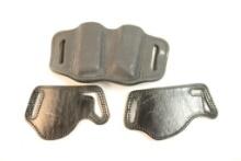 One leather belt double magazine holder, and two Bianchi model 101 foldaway belt slide holster.