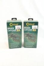 Two Caldwell universal brass catchers. In boxes.