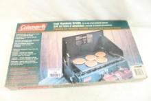 Coleman two burner propane stove with leather carry case, two bottles and cast aluminum griddle