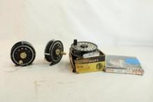 Three fly fishing reels and one roll of fly line