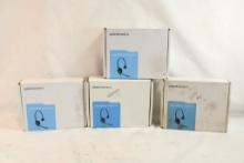 Four sets of Plantronics SupraPlus phone headsets in boxes used