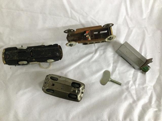 4 small tin litho cars - 1 in garage - all 1 $$