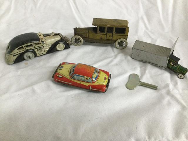 4 small tin litho cars - 1 in garage - all 1 $$