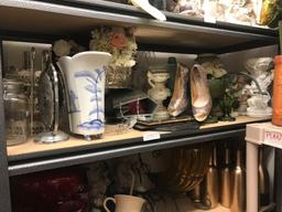 Shelf of tabletop decorations and beveled mirrors