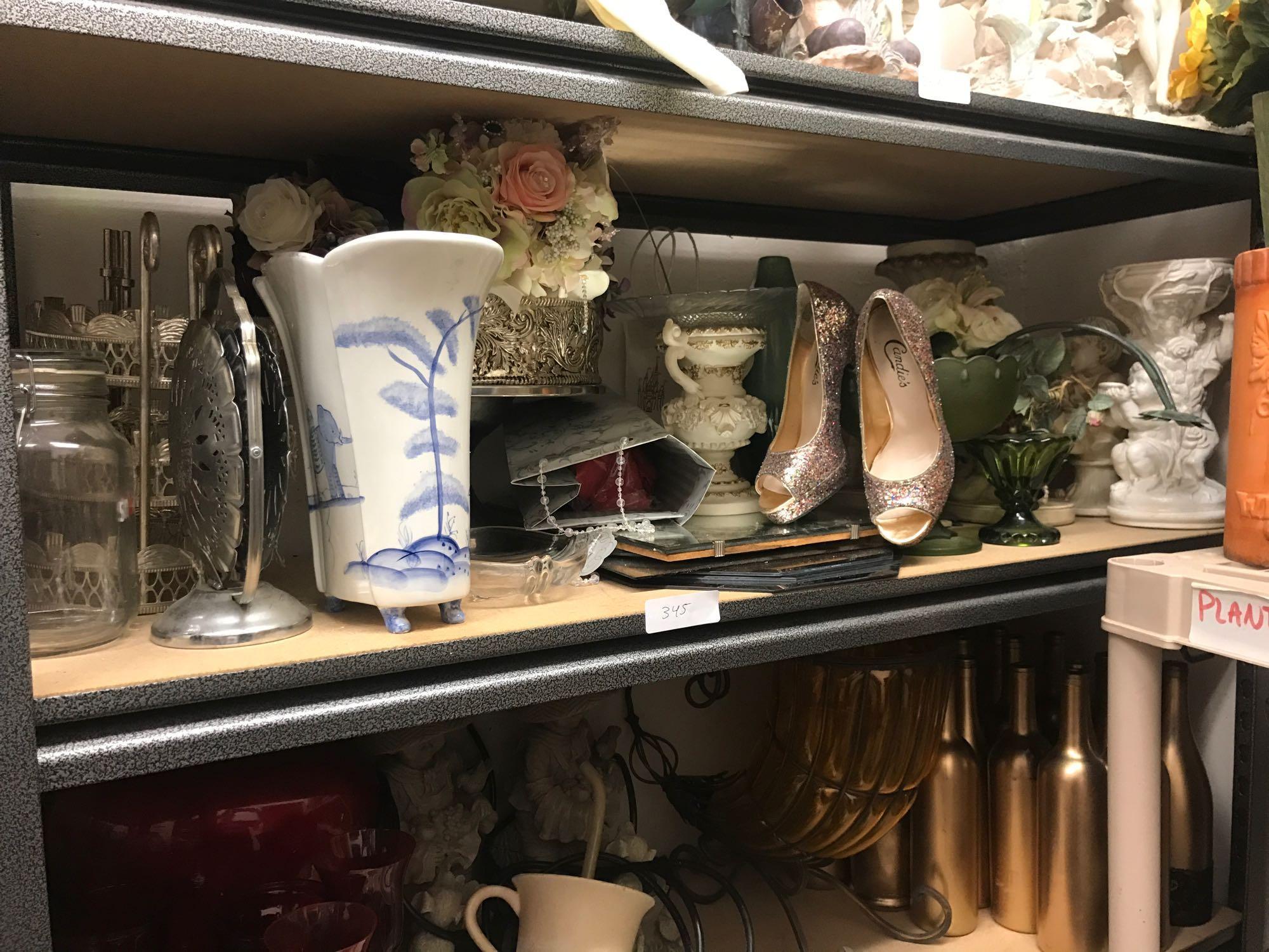 Shelf of tabletop decorations and beveled mirrors