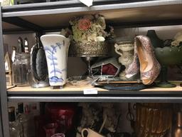 Shelf of tabletop decorations and beveled mirrors