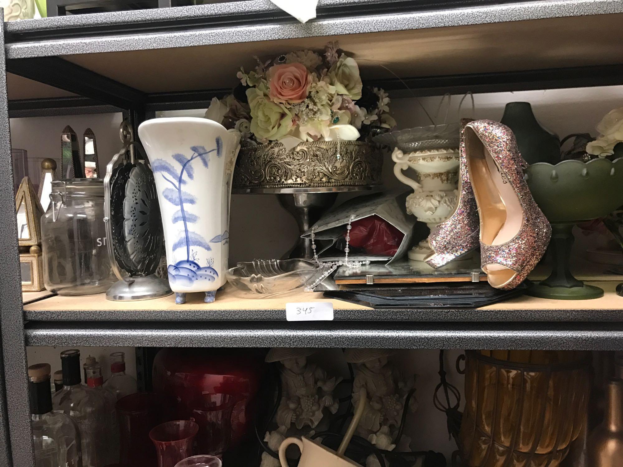 Shelf of tabletop decorations and beveled mirrors