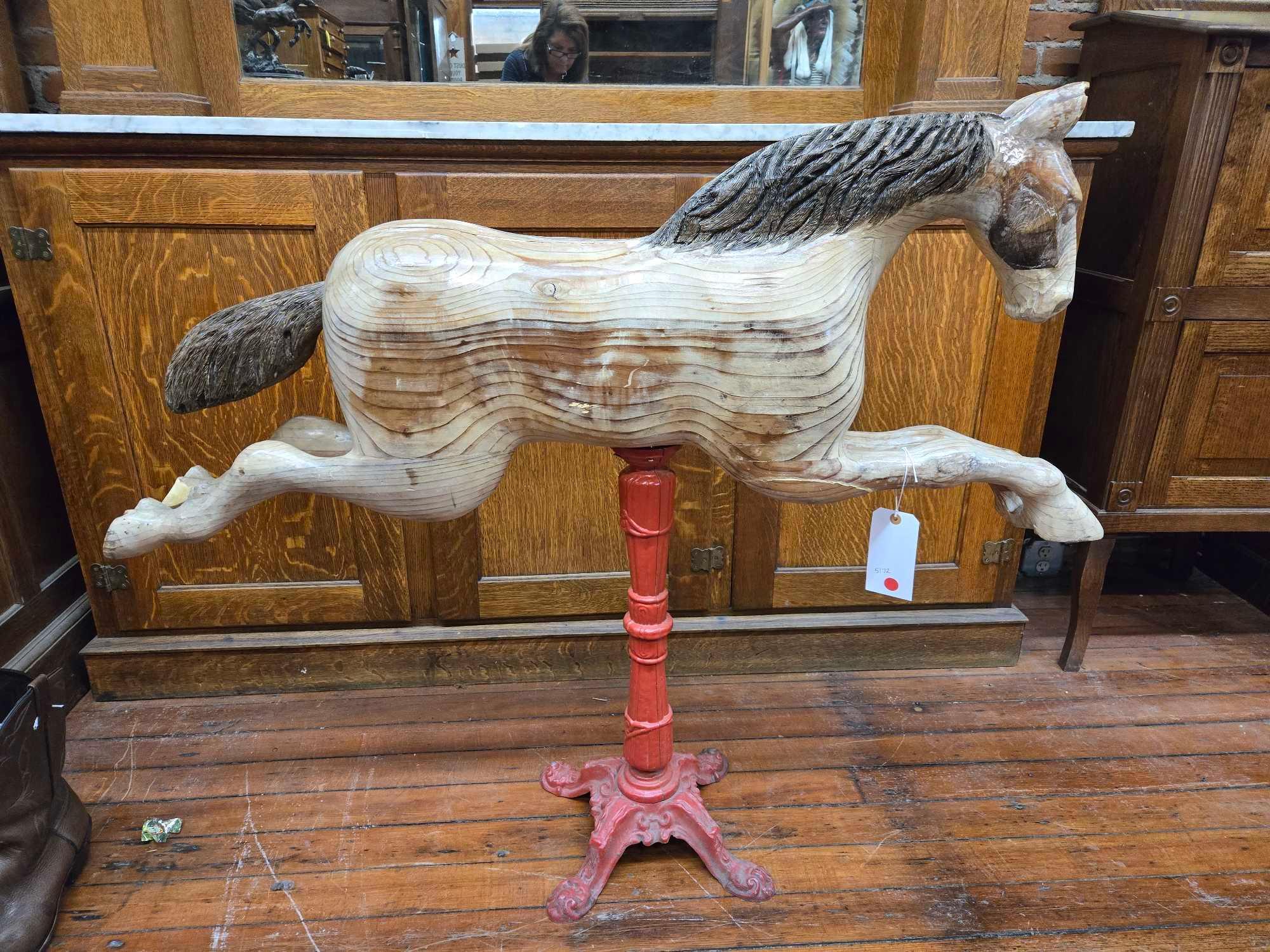 Carousel style hand carved wooden horse on metal stand