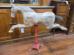 Carousel style hand carved wooden horse on metal stand