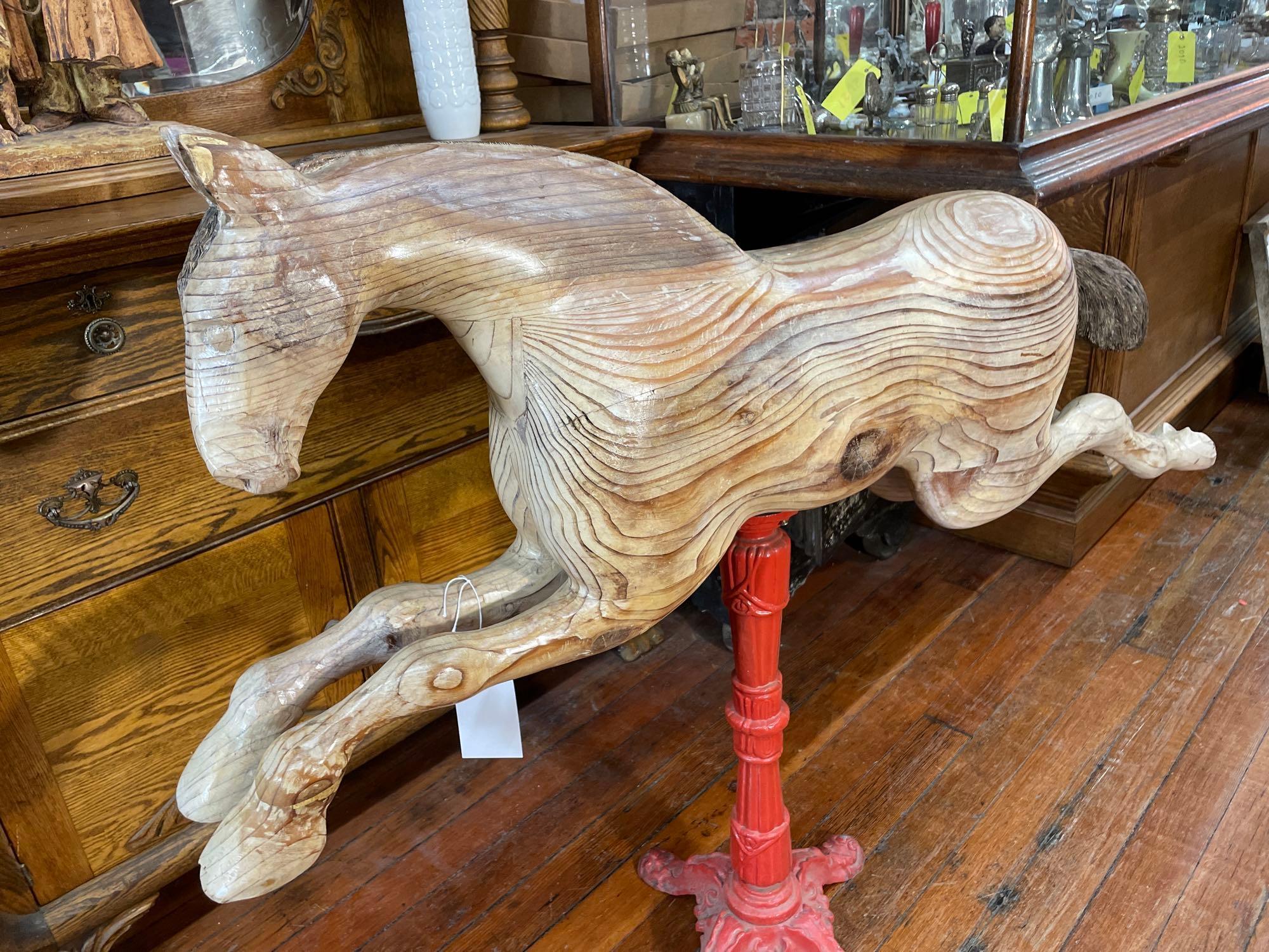 Carousel style hand carved wooden horse on metal stand