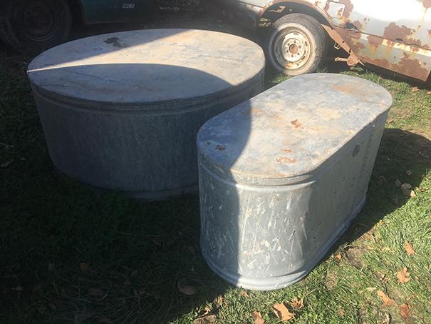 2 galvenized water tanks, appear to hold water