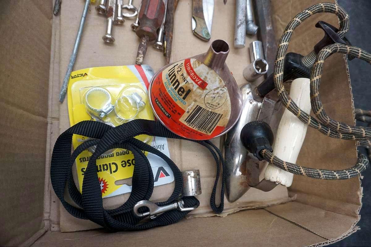 Box of tools, wire, iron, funnel, sockets, ratchet, keys. And more. Pocket knife.
