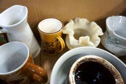 Box full of glassware, candleholders, and more.