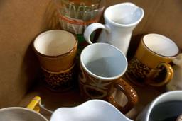 Box full of glassware, candleholders, and more.