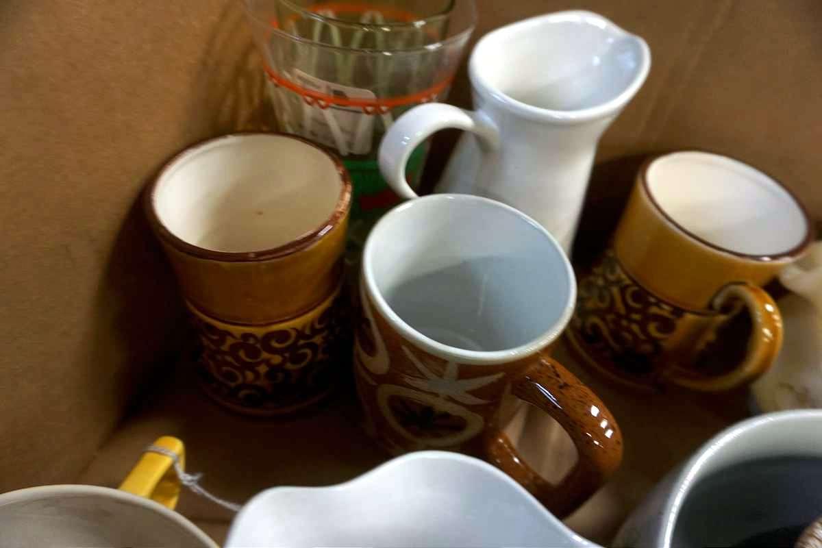Box full of glassware, candleholders, and more.