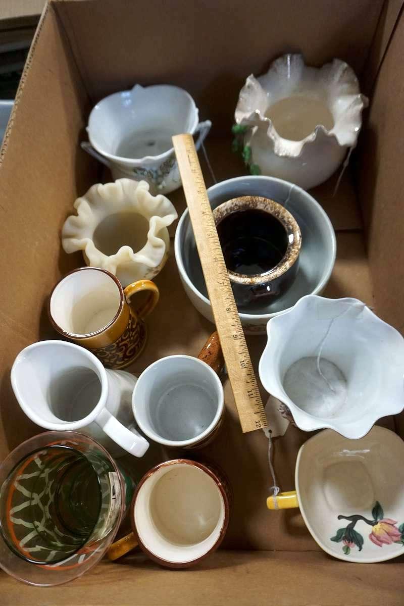 Box full of glassware, candleholders, and more.