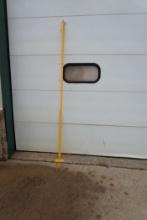 Yellow Tall Pole With Stakes In Base