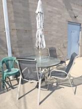 Glass top our door table with chairs and umbrella