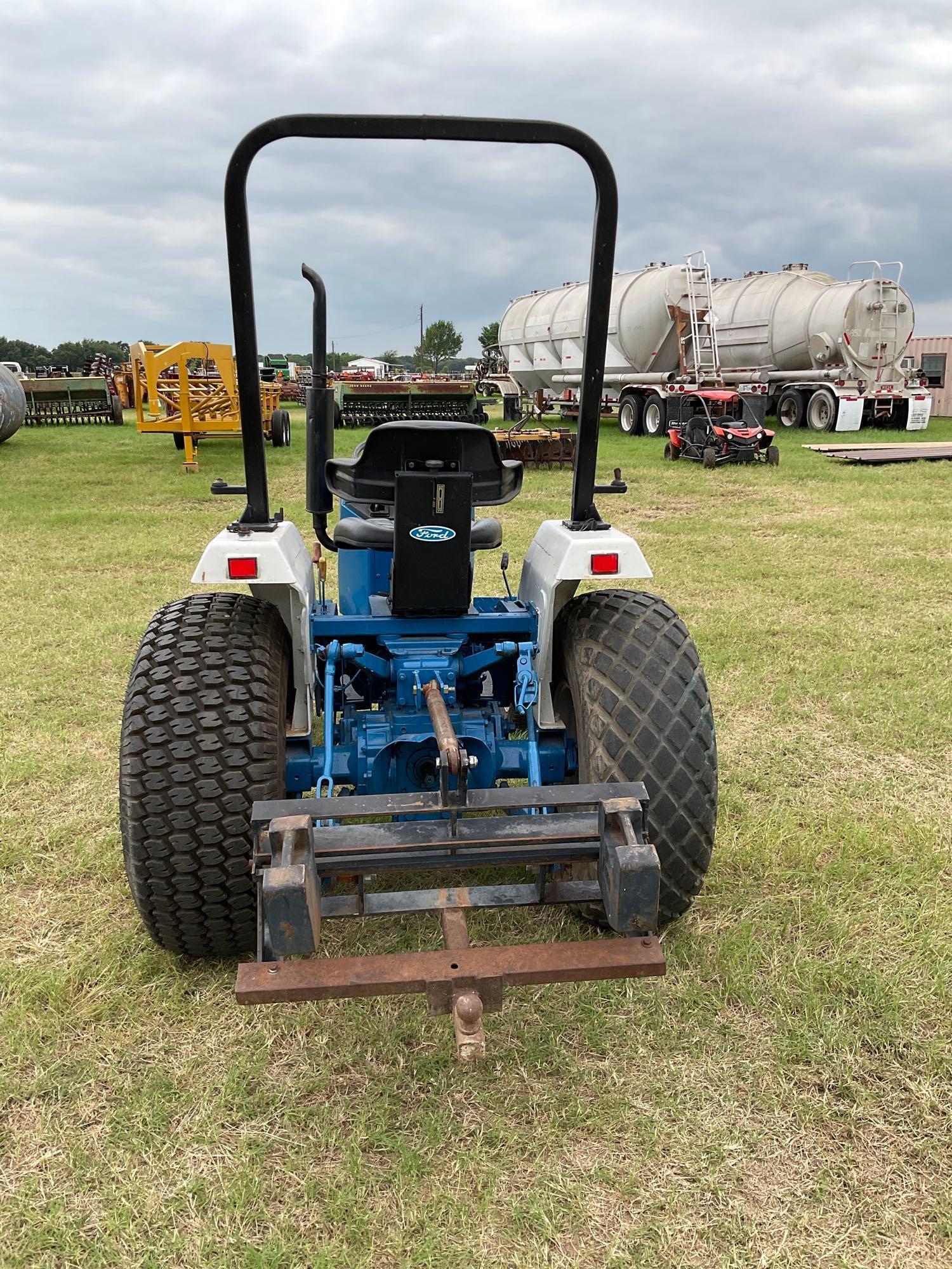 FORD 1520 WITH LOADER... DIESEL 2 WHEEL DRIVE... BUCKET WITH LOADER TURF TIRES ON THE TRACTOR REAR