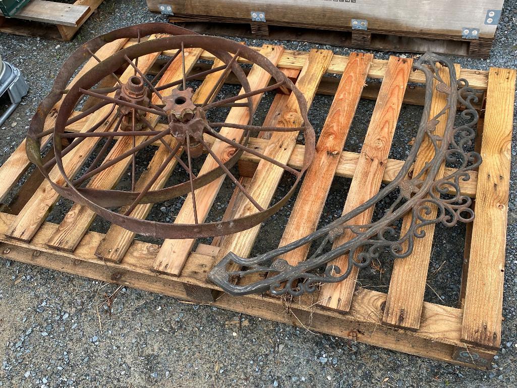 CAST IRON DECORATIVE PIECE AND TWO WAGON WHEELS