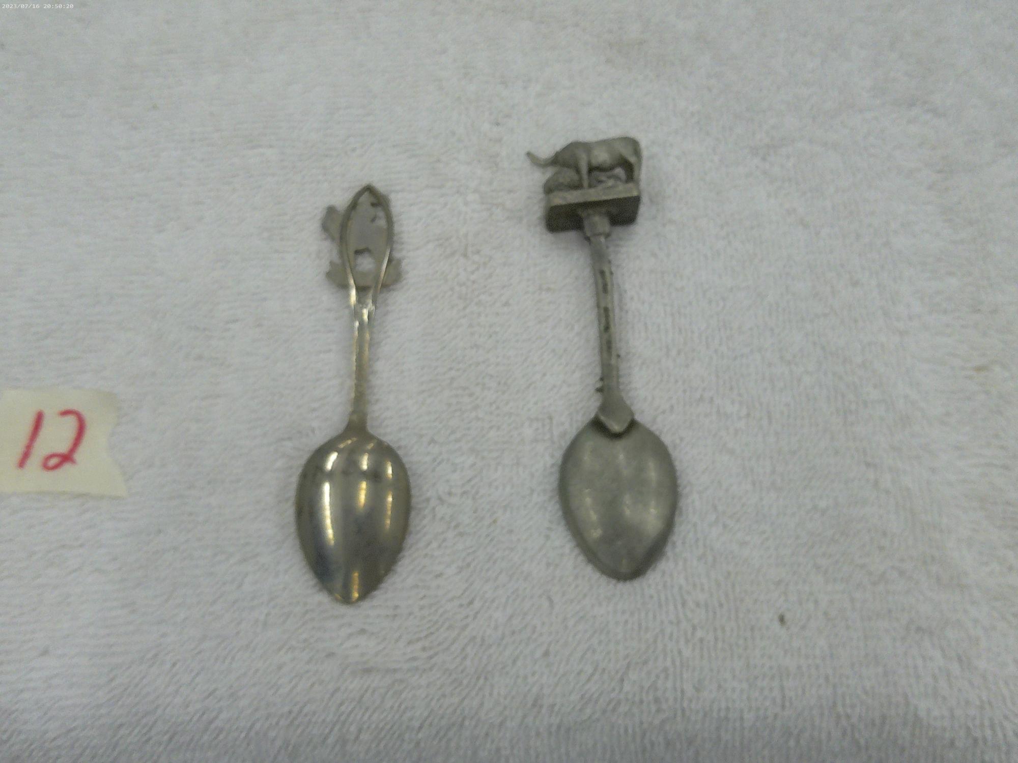 collector spoons, one from texas made in england and one from canada made in canada