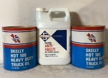 Two One Gallon Skelly HD Oil Cans and One Gallo Anti-Freeze Jug