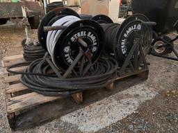 Pallet of pressure washer hoses and reels