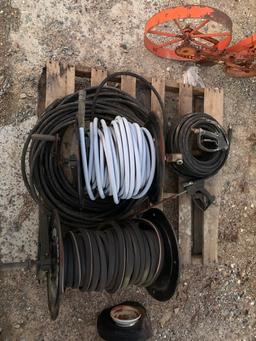 Pallet of pressure washer hoses and reels