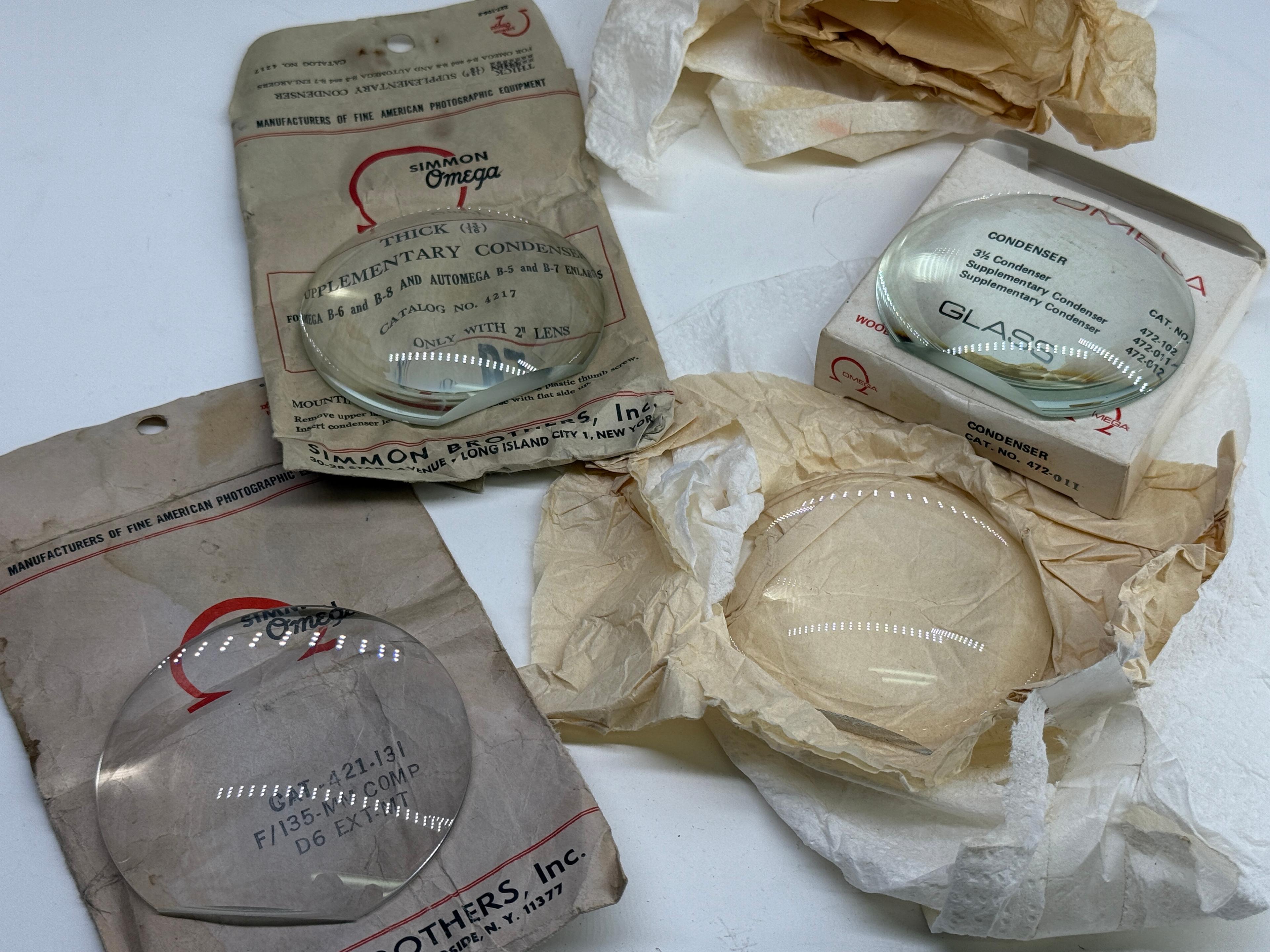 Assortment of Vintage Omega & Simmon Enlarger Condenser Lenses in Original Packaging