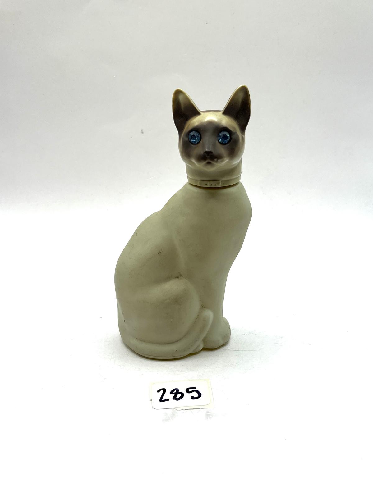 Cat with some liquid Avon bottle