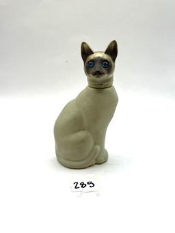 Cat with some liquid Avon bottle