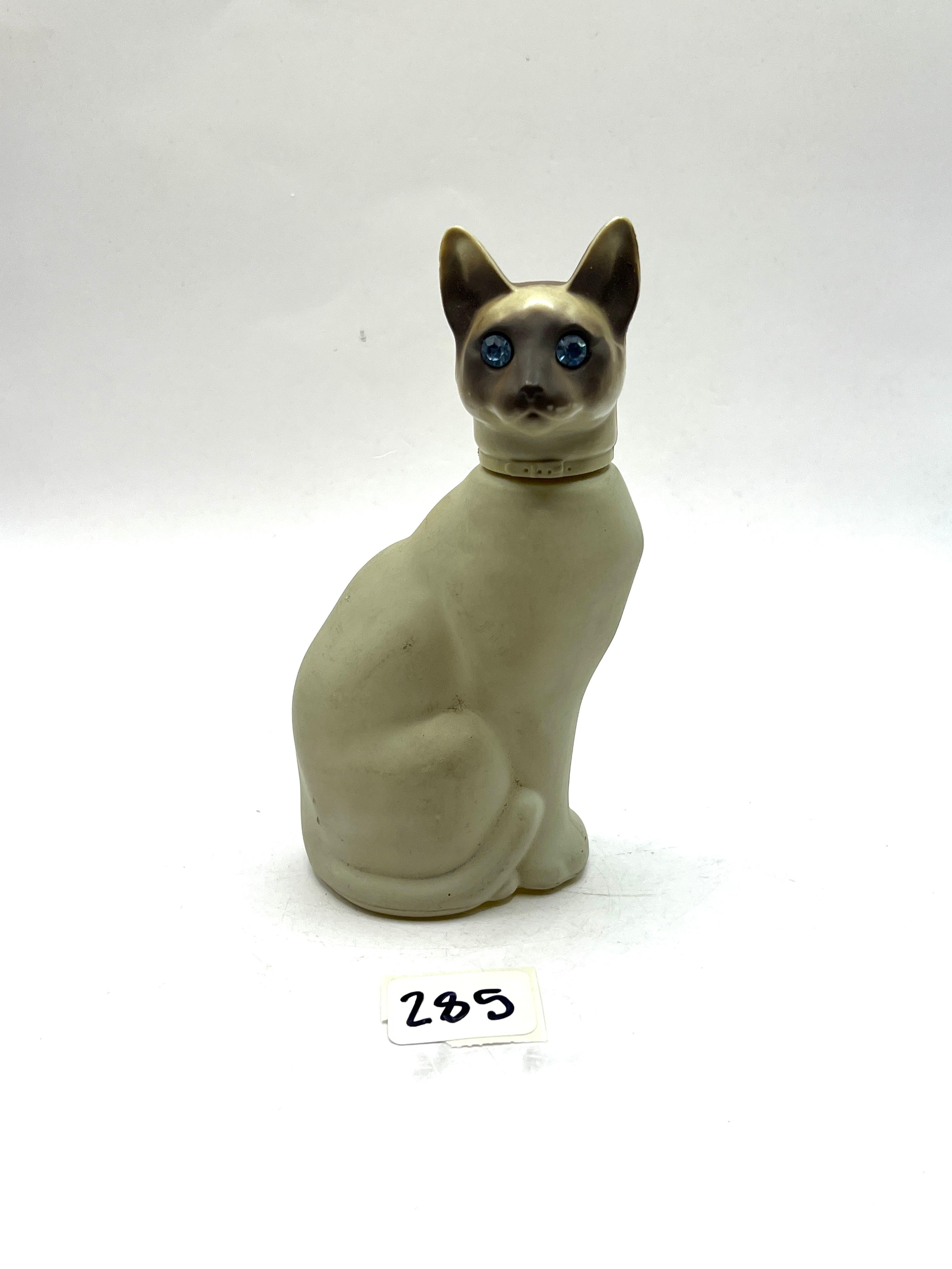 Cat with some liquid Avon bottle