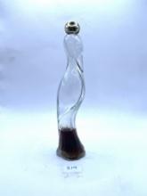 Flamingo decanter with some liquid Avon bottle