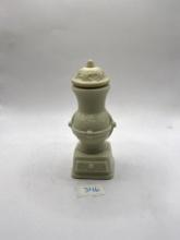White statue with liquid Avon bottle