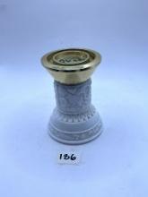 Candle stand with some liquid Avon bottle