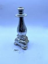Candle stand with some liquid Avon bottle