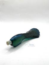 Peacock tail with some liquid Avon bottle