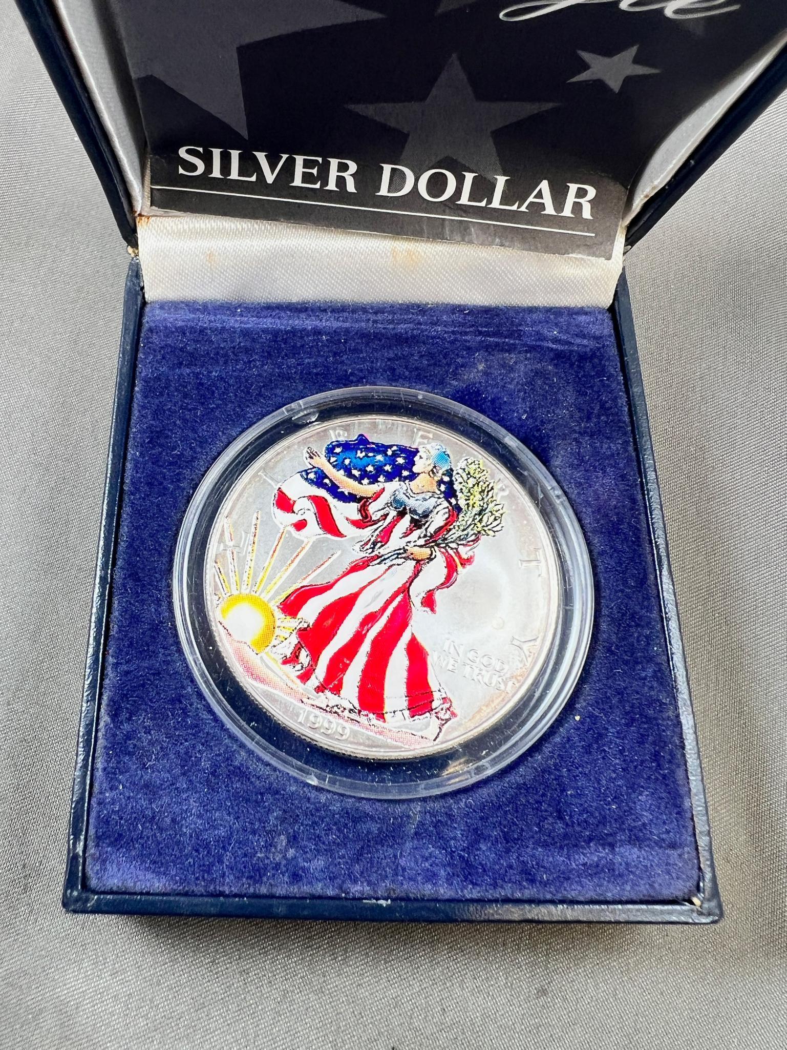 Painted 1999 US Silver Eagle coin in presentation box, .999 silver