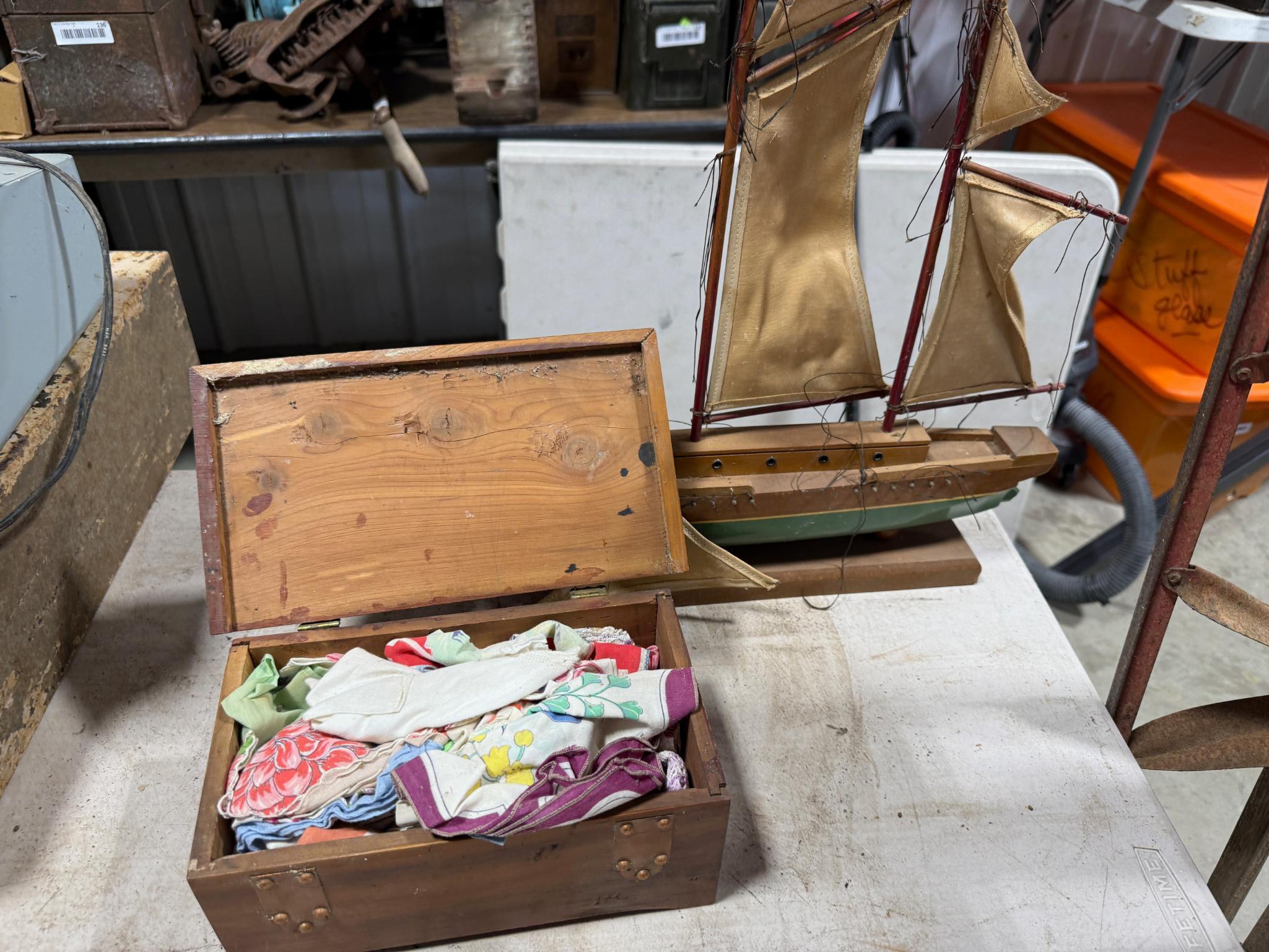 Cedar box full of vintage handkerchiefs and model sail boat