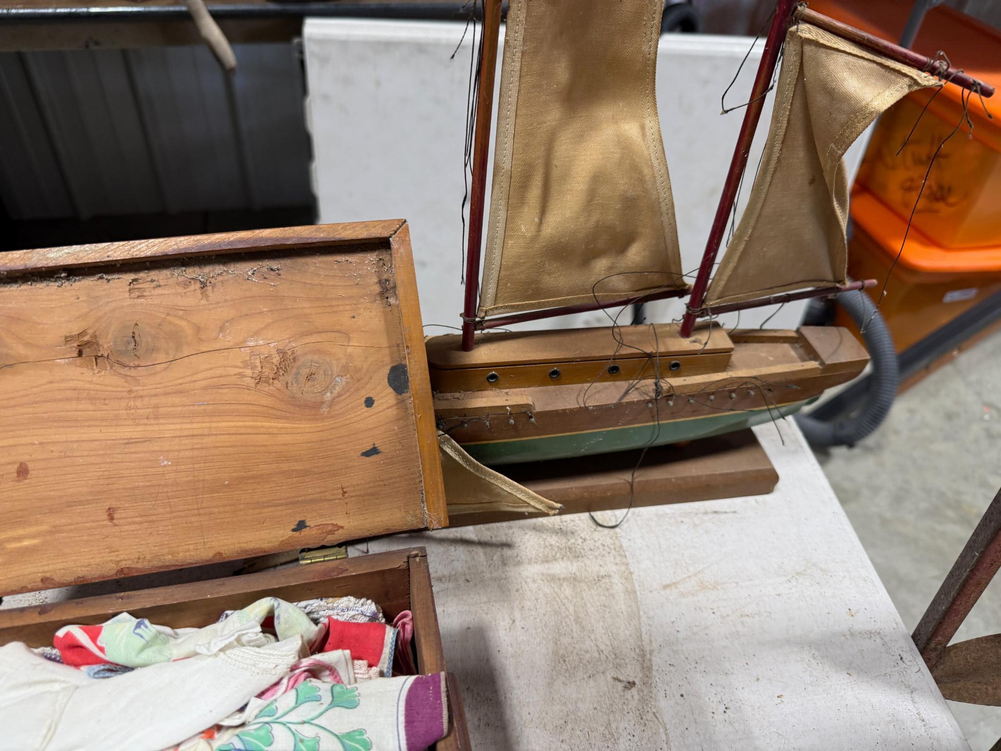 Cedar box full of vintage handkerchiefs and model sail boat