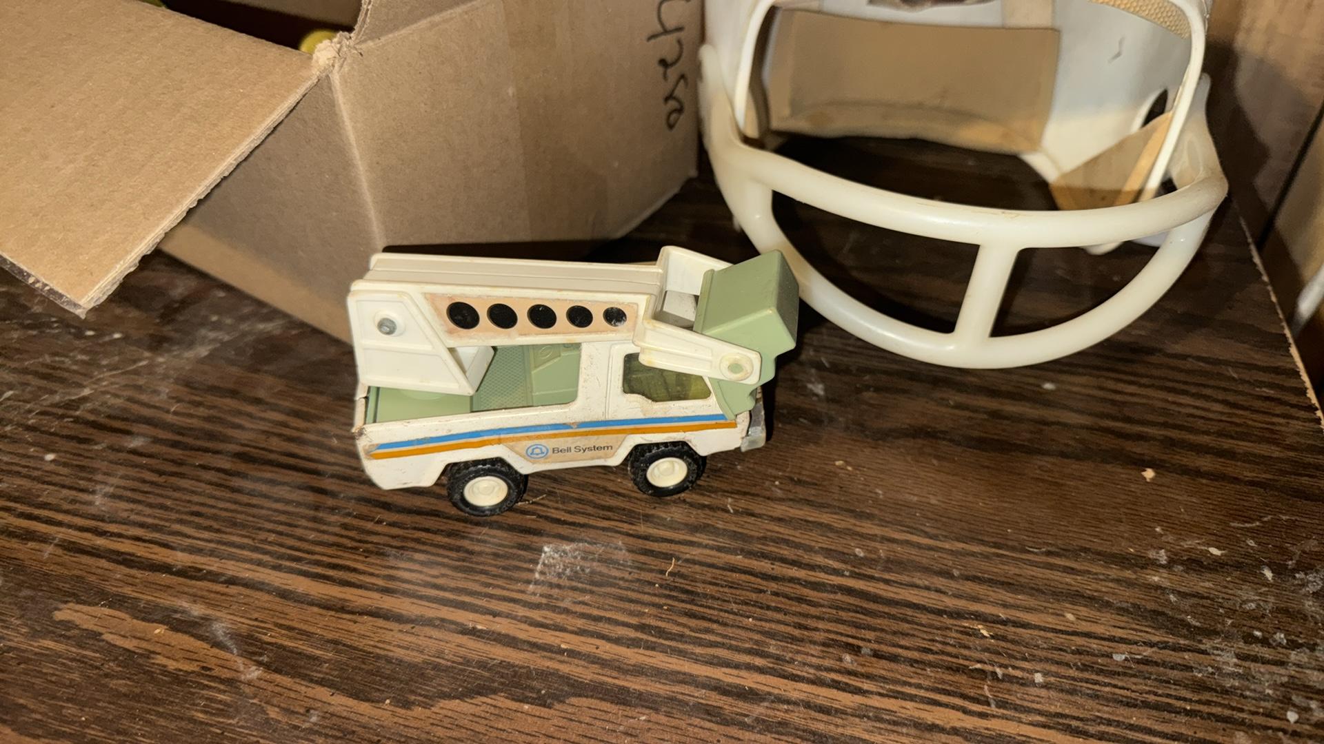 Vintage Football Helmet with Red Stripe and Toy Collection