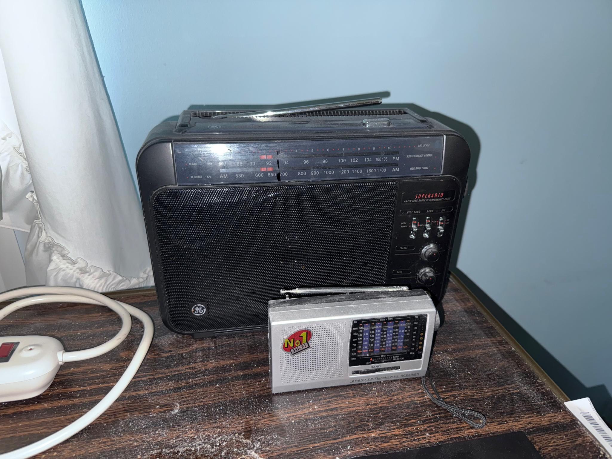 Bedside table w/ contents, light, and radios