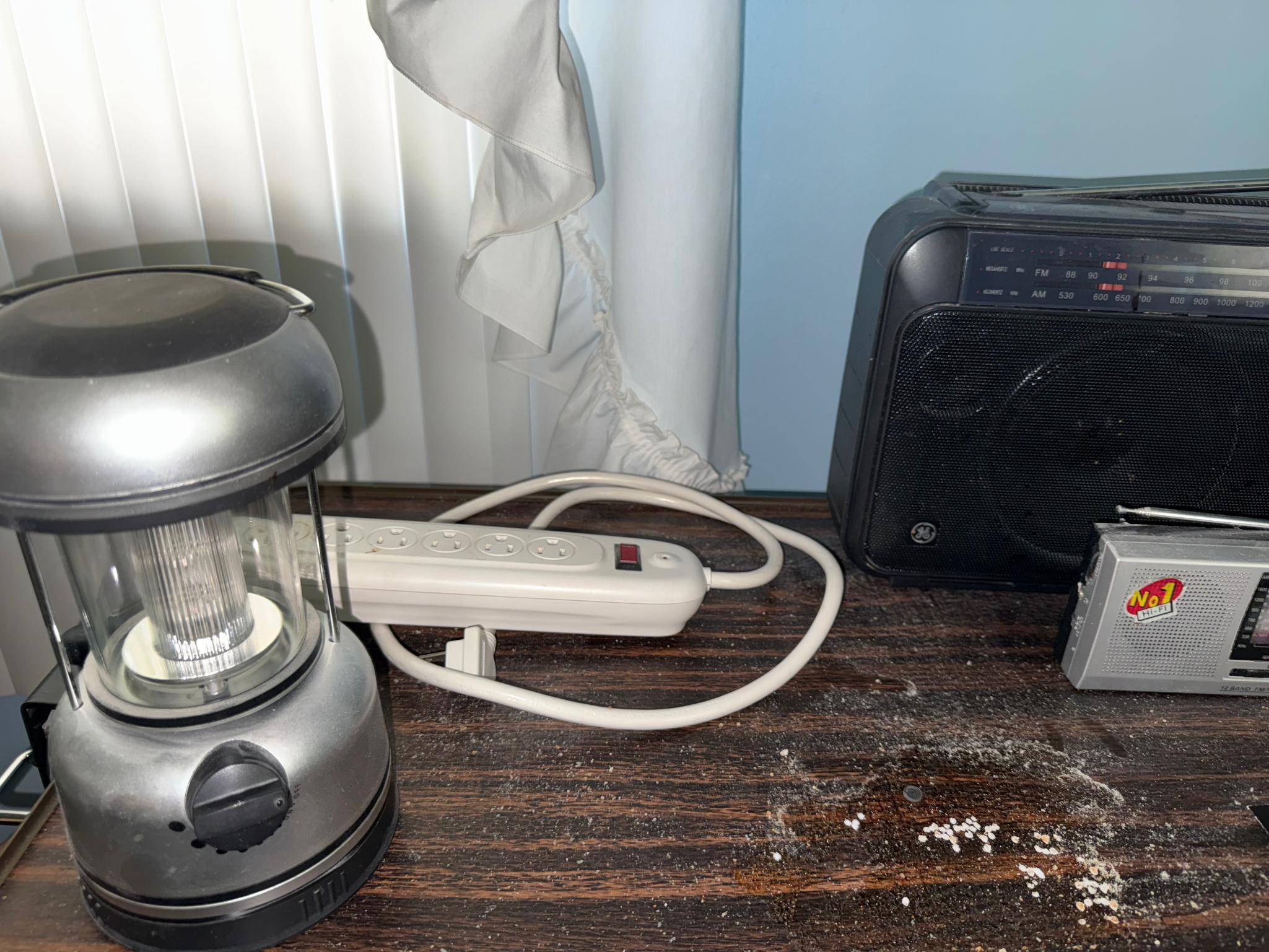 Bedside table w/ contents, light, and radios