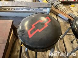 Goodwrench and Chevy bar stools, wooden coffee table, masking tape